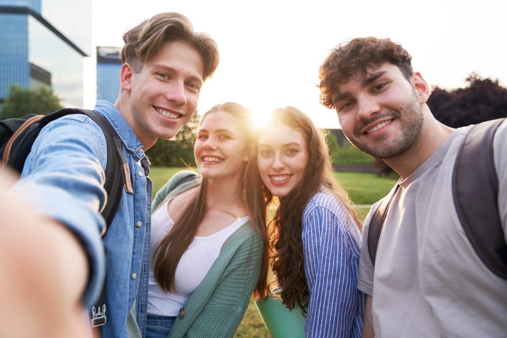 Portrait of four caucasian university students outside the university campus