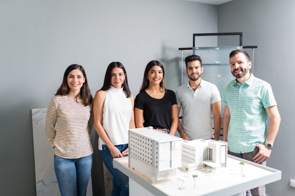 Smiling Architect Team With Model In Office